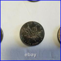 8- 1 oz silver coins with heavy toning libertad silver eagle maple leaf brtiania