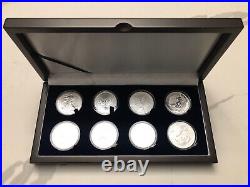 Collection of 8 Different 2022 BU World Silver Coins in a Wooden Display Case